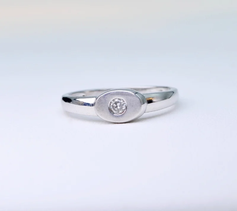 Simple Stacking Rings For Casual Brides-18K white gold ring with one small diamond set in an oval surface